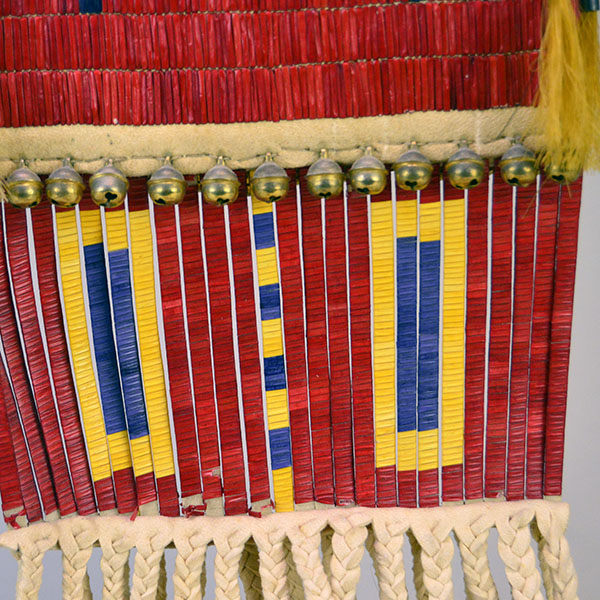 Pipe Bag- Double-sided Quillwork, Braintanned deerskin, braided fringe, cone‑drop tassels, and brass bells. Measures 45" with light age wear. The quilled strips with the tiny bells.