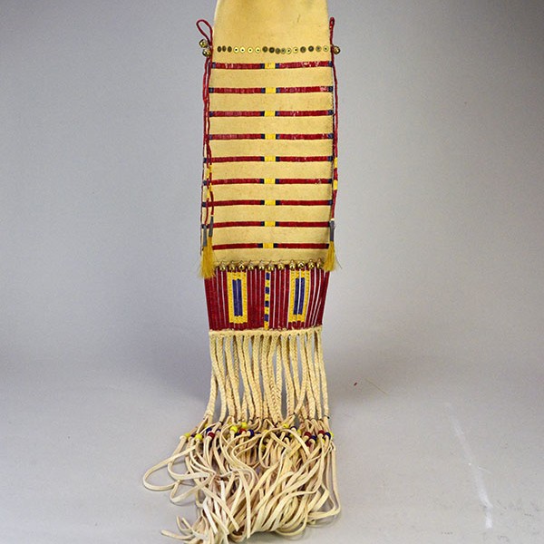Pipe Bag- Double-sided Quillwork, Braintanned deerskin, braided fringe, cone‑drop tassels, and brass bells. Measures 45" with light age wear. Pictured here is the back of the bag.