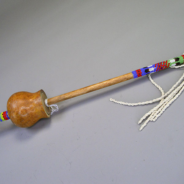 Dance Rattle Gourd- Beaded Handle with a real Bell Gourd, Peyote‑stitched beaded handle, twisted fringe, turquoise feathers, approx. 22.5 inches long.