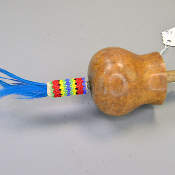 Dance Rattle Gourd- Beaded Handle with a real Bell Gourd, Peyote‑stitched beaded handle, twisted fringe, turquoise feathers, approx. 22.5 inches long. The gourd, the beaded design and the feathers.