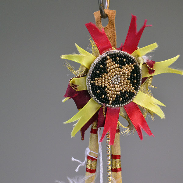 Scalp Feather- Gold Rosette, Hand‑painted eagle feathers, ribbon accents, and cowrie shell tassels. measures approx. 16.5" long.