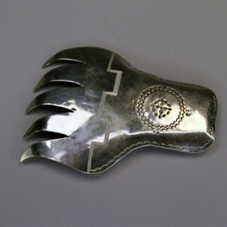 Vintage German silver Bear Paw scarf slide featuring stamped motifs and a soldered loop for easy threading. measures approximately 3.5″ long by 3″ wide.