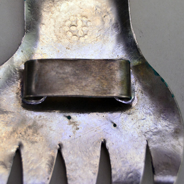 Vintage German silver Bear Paw scarf slide featuring stamped motifs and a soldered loop for easy threading. measures approximately 3.5″ long by 3″ wide. The back loop.