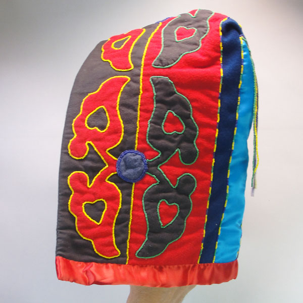 Skirt & Hood Set- Beaded Abstract floral motif, heavy wool, flannel lining, silk accents, bead outlines, approx. 30" × 45" for the skirt and 15" × 9" hood. this is one side of the hood.