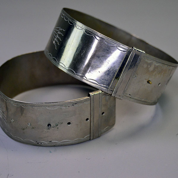 German Silver armband and cuff set with full hand‑stamped designs, maker’s marks “S” and “R,” plus NPW‑III‑1975 on cuffs. One of a Kind. Pictured here is the slide closure for the armbands.