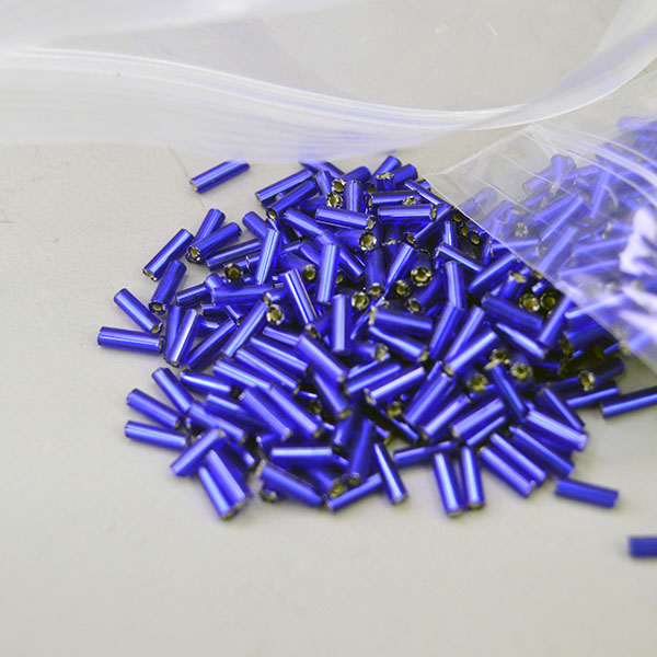 Bead Lot- Bugle Royal Blue are Silver‑lined in a 14‑oz lot. Sized 6mm×1.98mm, perfect for detailed beadwork, bold fringe and vibrant, high‑shine designs. Here is another view with the lighting and showing the shine.