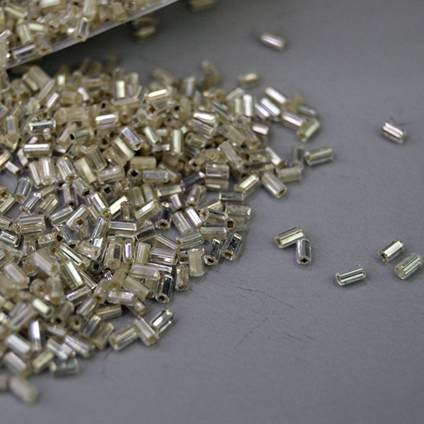 Bead Lot- Clear Silver Lined in a 17‑oz lot. Sized 3×1.98mm, perfect for detailed beadwork, shimmering fringe, and dimensional jewelry designs. Here is another angle showing the shine.