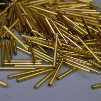 Bead Lot- Gold Bugle in 18‑oz lot, approx. 23mm. Their narrow diameter adds fine detail, texture, and fringe to beadwork, jewelry, and craft designs.