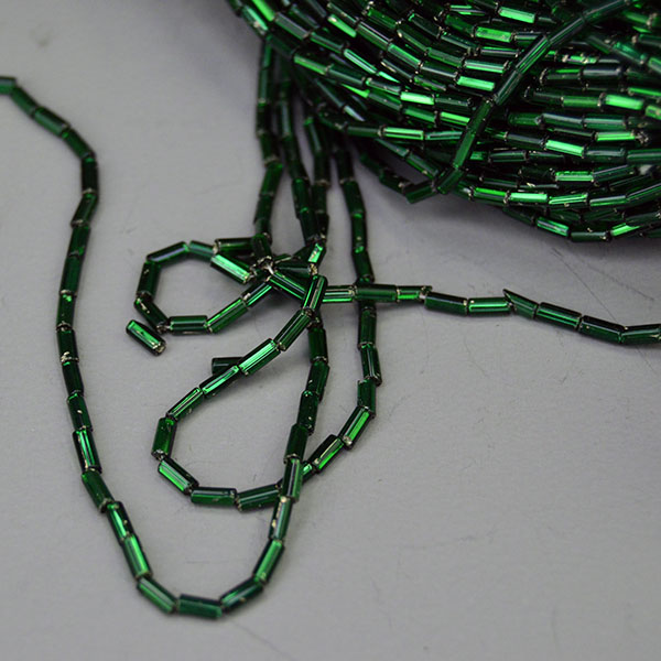 Bead Lot- Silver Lined Bugle dark green in a 17‑oz lot. Sized 4x2mm, perfect for detailed beadwork, bold fringe, and richly textured designs. limited stock. pictured here is showing the how long the bugle beads are.