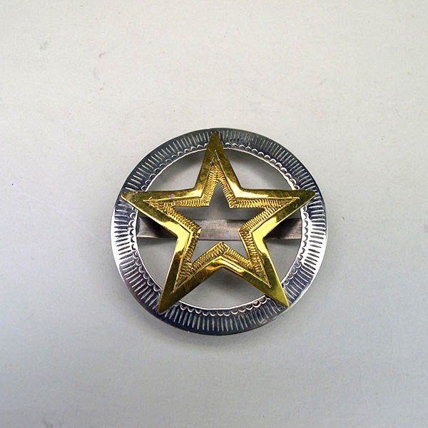 Hand‑stamped Brass Star Scarf Slide with German silver circle base. Measures 2.5″ x 2.5″. Bold, compact accessory for regalia, bandanas, and neckerchiefs.