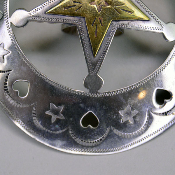 Handmade German silver Scarf Slide- Hearts & Stars, a brass accent, and a maker’s mark. Measures 3″ for bold regalia or everyday neckwear. Picture here is the hand stamped design , the cut out heart with stars around the edge.