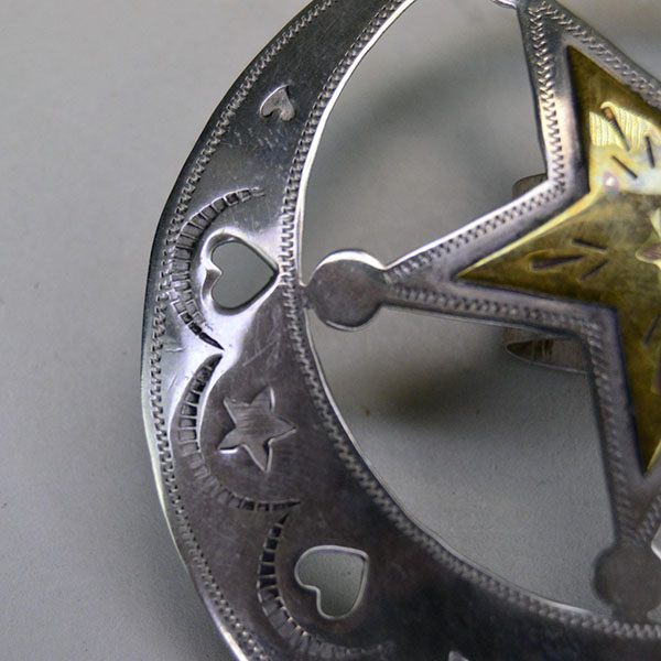 Handmade German silver Scarf Slide- Hearts & Stars, a brass accent, and a maker’s mark. Measures 3″ for bold regalia or everyday neckwear. Here are is a heart cut out and the hand stamped design.