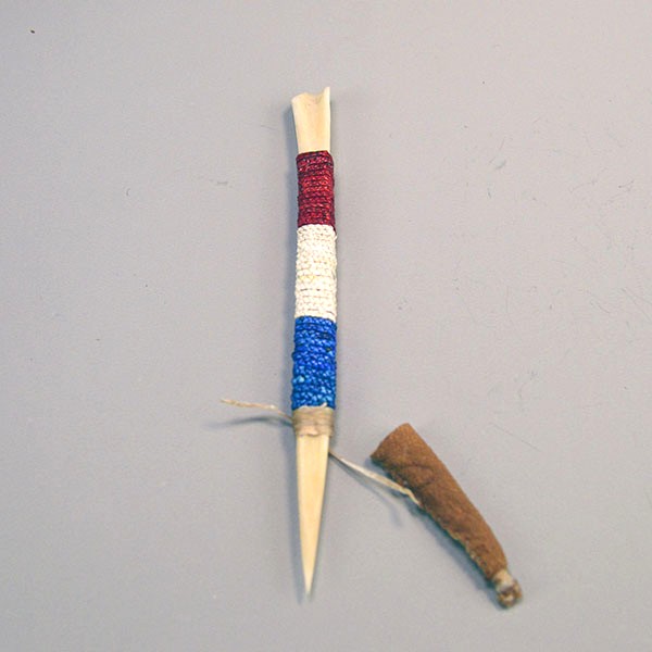 Hand‑quilled Awl- Deer Bone Quilled with red, white, and blue quillwork, secure sinew wrap, and protective leather cover. Approx. 6" long. One of a Kind.