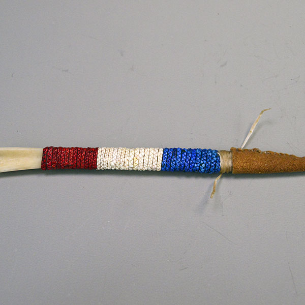 Hand‑quilled Awl- Deer Bone Quilled with red, white, and blue quillwork, secure sinew wrap, and protective leather cover. Approx. 6" long. One of a Kind. the Red, White and Blue quill work .