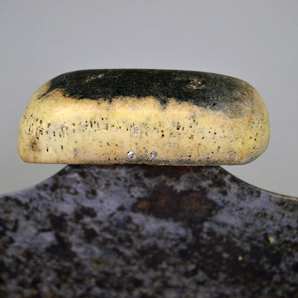 Vintage Knife- Vintage ULU with a 6" crescent blade and carved bone handle (2.25" x 1"), offering authentic traditional craftsmanship for collectors. The side of the bone handle.