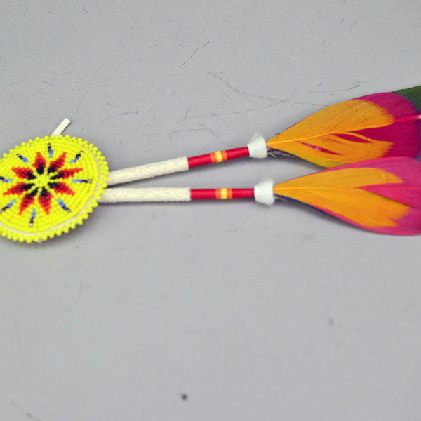 Add vibrant color and traditional craftsmanship to your regalia with this Macaw & Rosette Scalp Feather Set. This colorful piece features detailed beadwork. Pictured here is the beaded roach, the thread wrapped , the ermine accents with the feather accents.