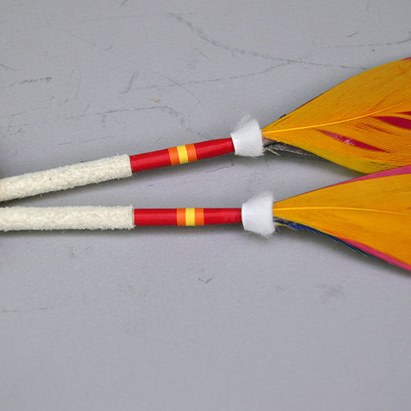 Add vibrant color and traditional craftsmanship to your regalia with this Macaw & Rosette Scalp Feather Set. This colorful piece features detailed beadwork. Pictured here is the ermin accents , the thread wrapped and the orange accent feathers.
