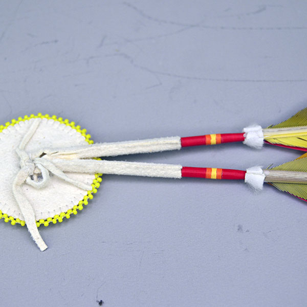 Add vibrant color and traditional craftsmanship to your regalia with this Macaw & Rosette Scalp Feather Set. This colorful piece features detailed beadwork. pictured here is the back showing how the rosette is attached.