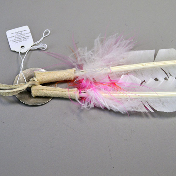 Scalp Feather- Stamped Concho, Hand‑painted scalp feather with a stamped concho, cut designs, pink fluffs, and traditional detailing. Measures 12.5 inches. Pictured here is the back showing how the concho is attached.