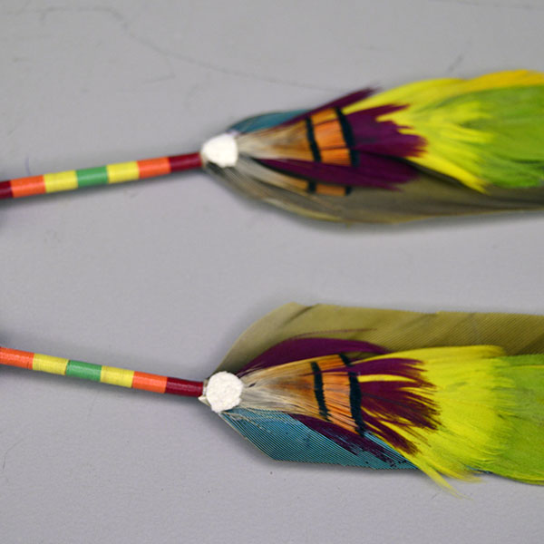 Scalp Feathers- Peyote Stitch with a 1.5″ beaded rosette, 2″ peyote stitch, thread wraps, ermine accents. Feathers measure 7″; full piece measures 12″. Pictured here is the accent feathers at the bottom of the macaw feathers and the thread wrapped design.