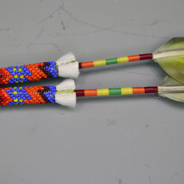 Scalp Feathers- Peyote Stitch with a 1.5″ beaded rosette, 2″ peyote stitch, thread wraps, ermine accents. Feathers measure 7″; full piece measures 12″. Pictured here is the ermine accent next to the peyote stitch and the thread work.