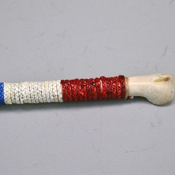 Whistle- Bird Wing Bone Quilled with braided red, white, and blue porcupine‑quillwork and a secure sinew wrap. Approx. 5.5 inches long. One of a kind. The quill work up close.