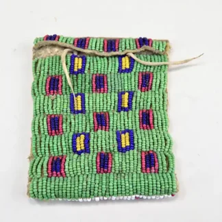 Antique Bag- Strike a Lite Beaded, smoked Braintanned leather, trans cobalt, greasy yellow, white center red. Measures approx. 4" × 3". one of a kind