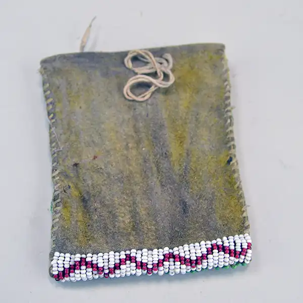 Antique Bag- Strike a Lite Beaded, smoked Braintanned leather, trans cobalt, greasy yellow, white center red. Measures approx. 4" × 3". one of a kind. Pictured here is the back of the bag and the white and white center red design on the bottom.