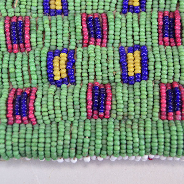 Antique Bag- Strike a Lite Beaded, smoked Braintanned leather, trans cobalt, greasy yellow, white center red. Measures approx. 4" × 3". one of a kind. Pictured here is an up-close of the beads and the square design.