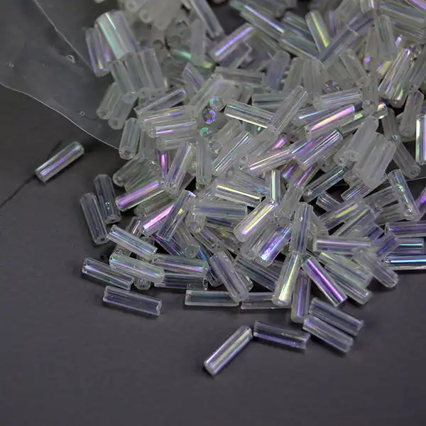 Shop 18 oz of Bead Lot- Iridescent White Bugle beads. Perfect for beadwork, fringe, regalia, jewelry making, and craft projects that shine. 7 mm long.