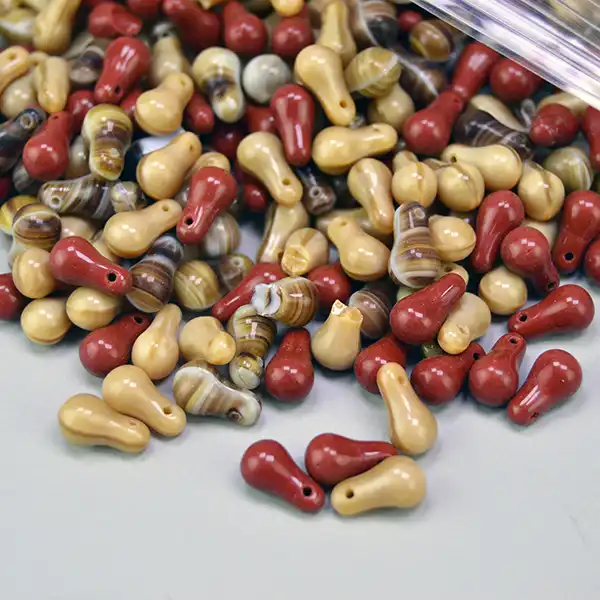 21 oz lot of pressed glass Bead Lot- Tear Drop Shape beads in warm brown hues. Ideal for unique jewelry designs, beadwork, and creative craft projects.