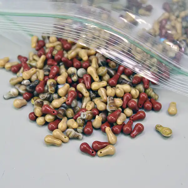 21 oz lot of pressed glass Bead Lot- Tear Drop Shape beads in warm brown hues. Ideal for unique jewelry designs, beadwork, and creative craft projects.