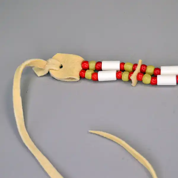 Choker- Greasy Yellow & Red this two-row choker features buffalo hairpipe, bone tube beads, shell conchos, and vibrant red and yellow beadwork. The ties.