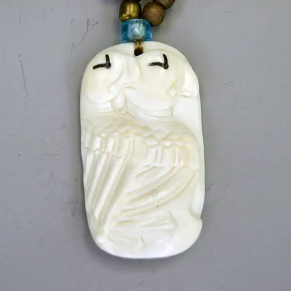 Choker- Two Row by Andy Bullock with buffalo tubes, hairpipe, crow beads, and etched bone pendant. Approx. 14.5″ with 5″ drop. One of a Kind. The bird bone pendant.