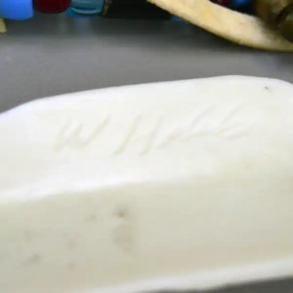 Choker- Two Row by Andy Bullock with buffalo tubes, hairpipe, crow beads, and etched bone pendant. Approx. 14.5″ with 5″ drop. One of a Kind. Here is a picture of the makers mark on the back of the pendant.