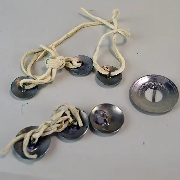 Mixed Group Lot- Conchos & Brooch with six German silver conchos and a hand‑stamped 1.75" brooch— back view