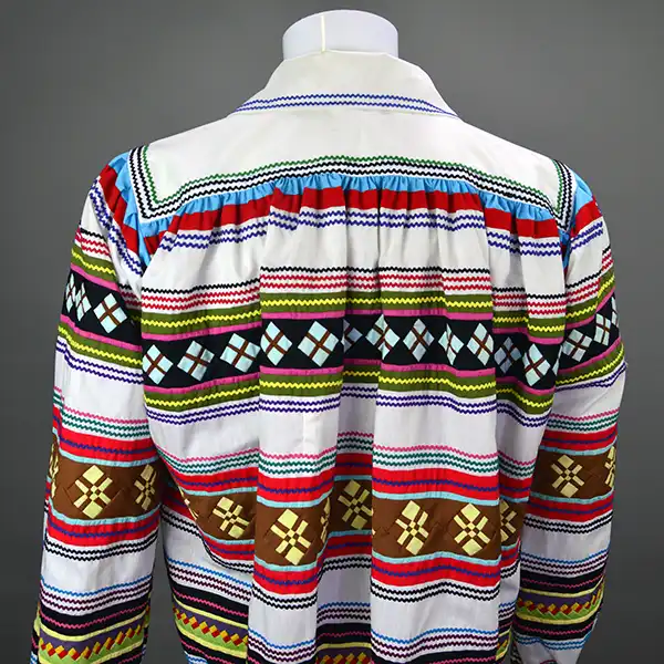 Vintage Jacket- White Seminole with early 20th‑century patchwork, bat‑wing sleeves, interior stitching, and medium–large sizing. ONE OF A KIND. The back of the jacket.
