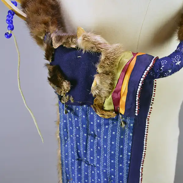 Necklace- Carved Bear Claw with cobalt blue glass beads and a removable ribbon work drop featuring beadwork, silver brooches, and otter fur. One of a Kind. Pictured here is the otter fur that has dry rot.