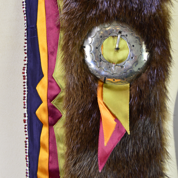 Necklace- Carved Bear Claw with cobalt blue glass beads and a removable ribbon work drop featuring beadwork, silver brooches, and otter fur. One of a Kind. The other silver brooch with the ribbon work and the otter fur.