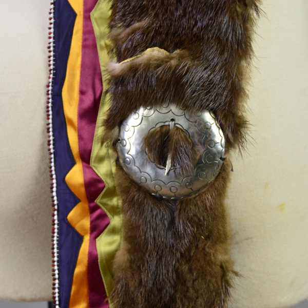 Necklace- Carved Bear Claw with cobalt blue glass beads and a removable ribbon work drop featuring beadwork, silver brooches, and otter fur. One of a Kind. One of the silver brooches with the ribbon work and the otter fur.