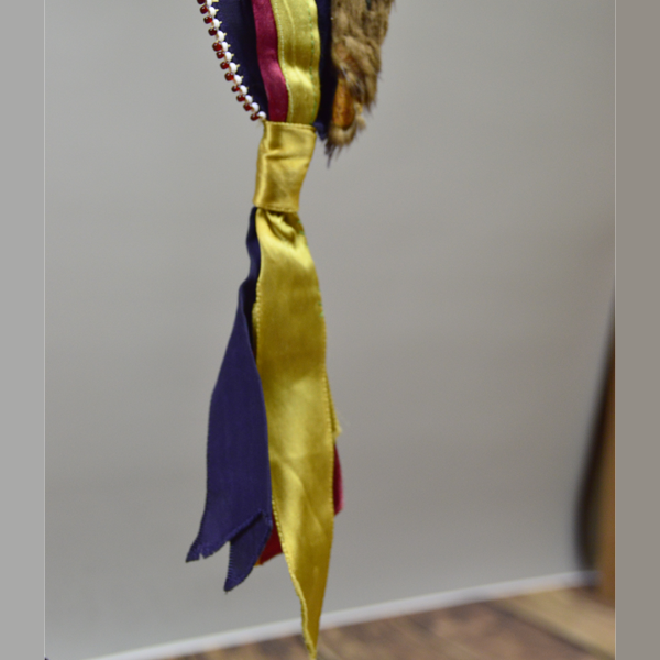 Necklace- Carved Bear Claw with cobalt blue glass beads and a removable ribbon work drop featuring beadwork, silver brooches, and otter fur. One of a Kind. The drop ribbon work.