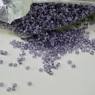 Add rich purple color to your beadwork with French 12/0 Seed Beads- Translucent Amethyst Ideal for regalia, rosettes, jewelry, and craft designs.