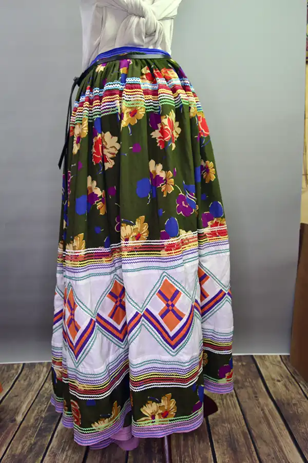 Vintage Skirt & Blouse- Seminole set with patchwork and geometric banding, rickrack trim, and classic strip‑piecing. One of a Kind. The skirt with the floral back round and the Ric rack design and the patch work design.