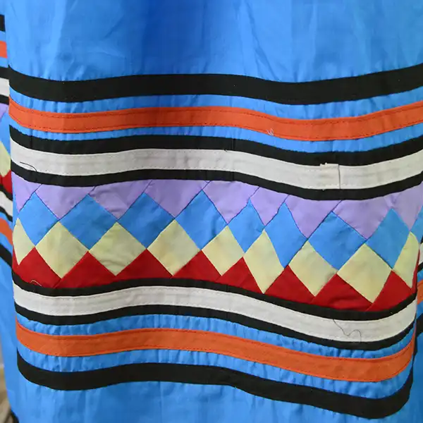 Vintage Skirt- Light Blue Seminole with colorful patchwork and multicolor ribbon work, showing gentle wear and traditional Seminole craftsmanship. The colorful patch work design.