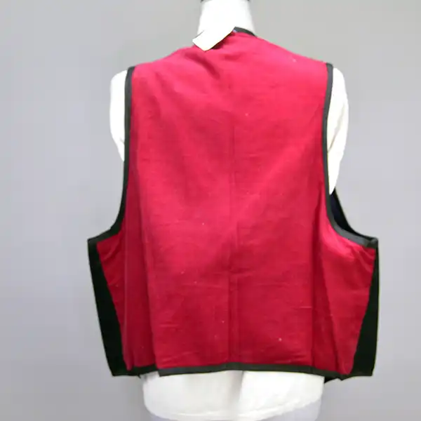 Contemporary Vest- Ribbon Work featuring vibrant purple, orange, gold, and blue designs, black fox braid trim, silk lining, and a red corduroy back. The back view.